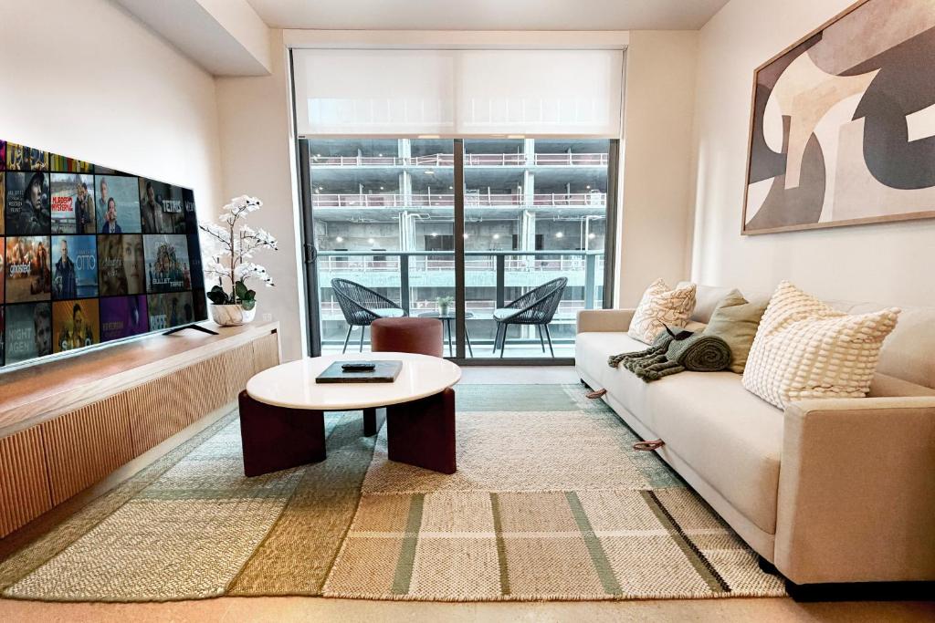 a living room with a couch and a table at Stylish Condo at The Crosby in Miami