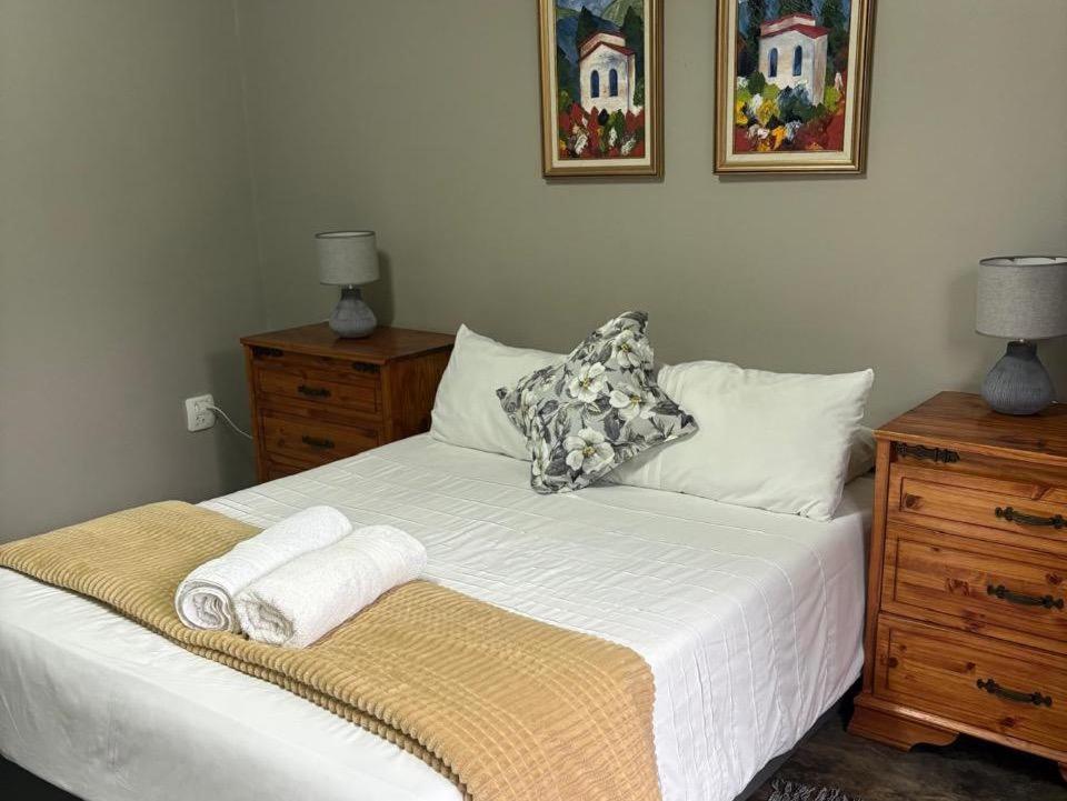 a bedroom with a bed with towels on it at Hekpoort Rorymi Guest farm in Hekpoort