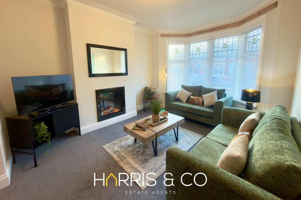 a living room with a couch and a fireplace at Driftwood Bay in Fleetwood