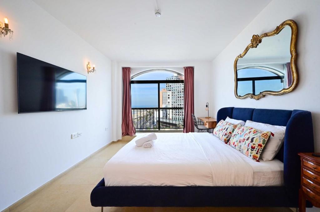 a bedroom with a large bed and a mirror at (Floor Shelter)Luxury Sea View w/Pool Inside Hotel in Tel Aviv
