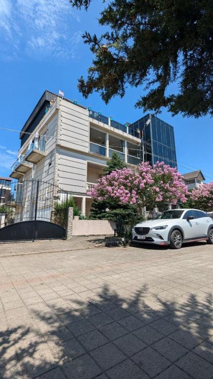 a white car parked in front of a building at TIRKIUS House in Kobuleti