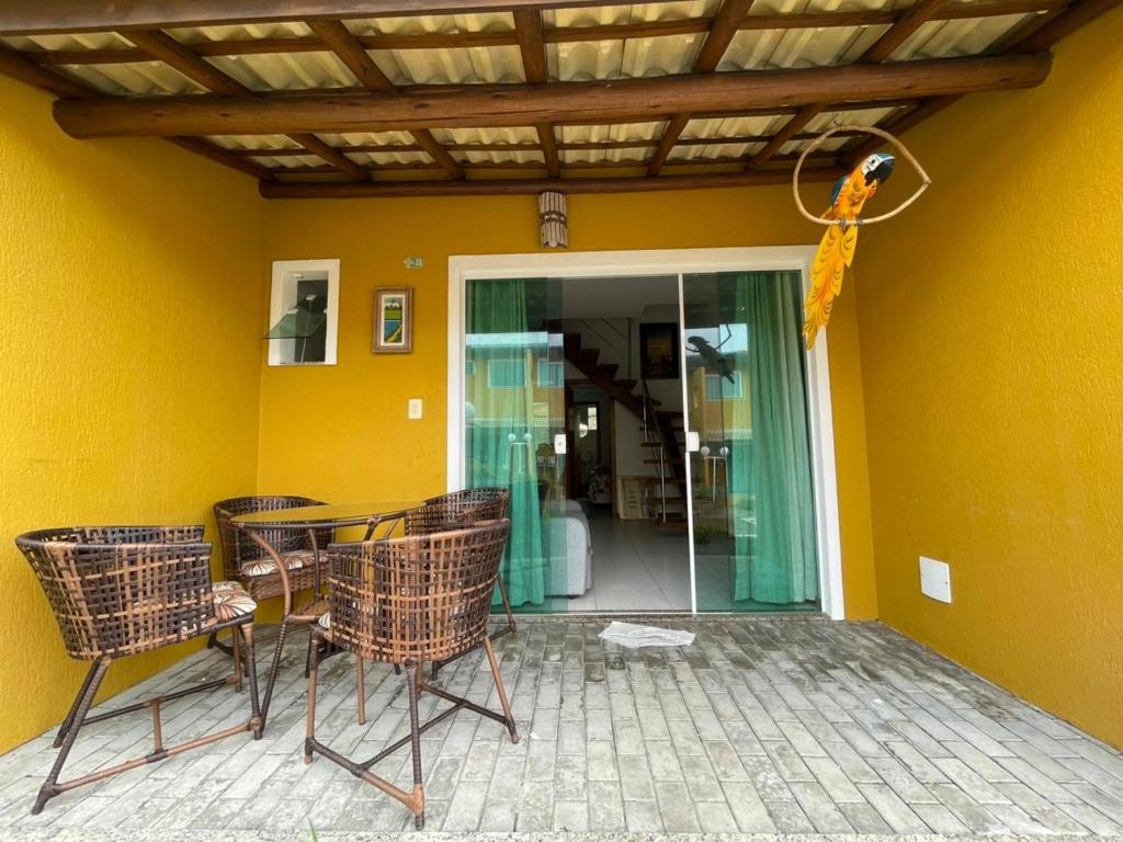 a group of chairs sitting on a patio at Casa summer flats 23 Imbassai in Imbassai