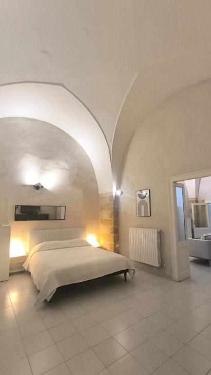 a bedroom with a bed in a large room at Celebes in Brindisi