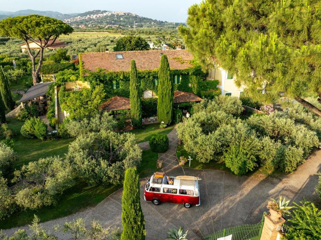 a red van parked in front of a house with trees at La Meridiana in Lanuvio
