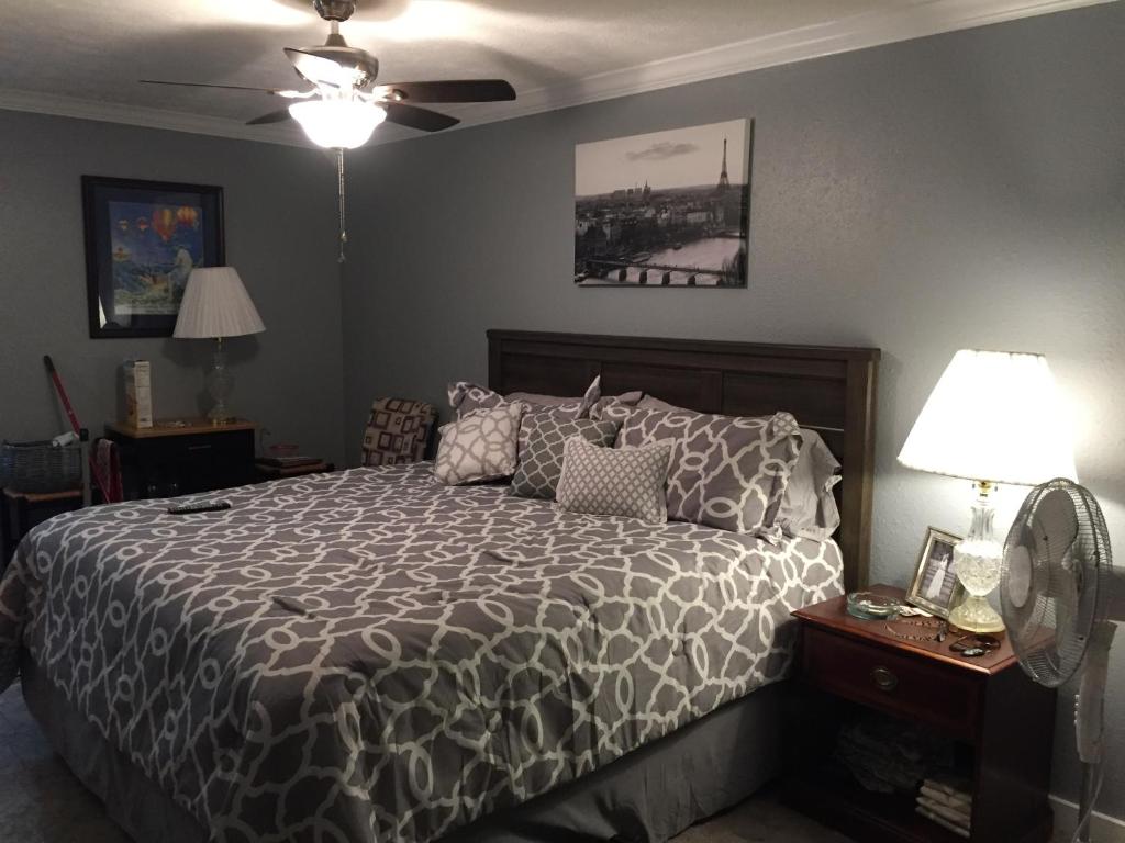 a bedroom with a bed with a black and white comforter at Gators Inn on the Bayou in Larose