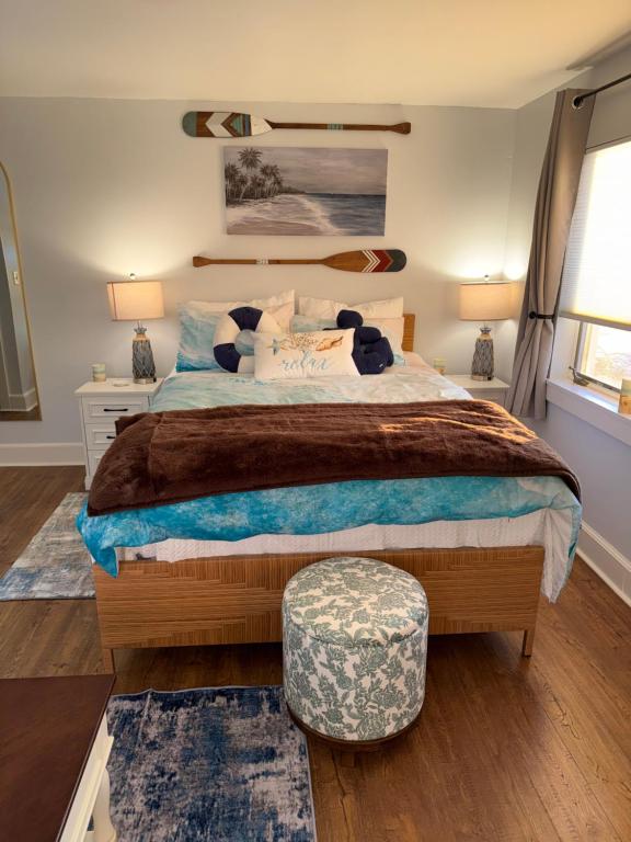 a bedroom with a large bed and a ottoman at Pet friendly waterfront condo in Edgecomb