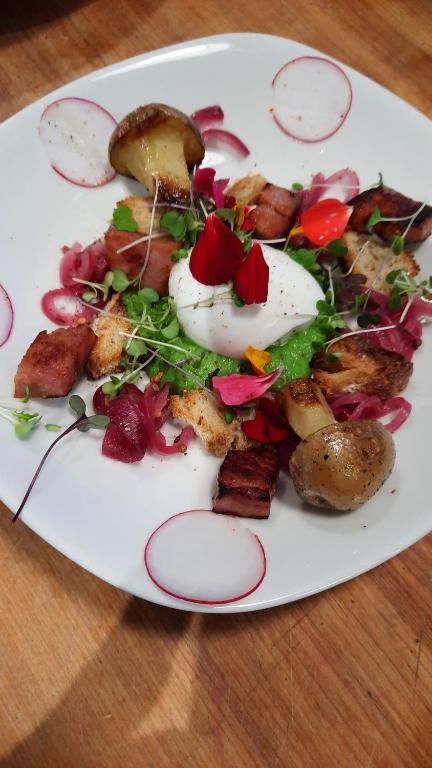 a plate of food with an egg on a table at La maison de l'île d'Orléans - B&B - déjeuner gastronomique in Saint-Jean