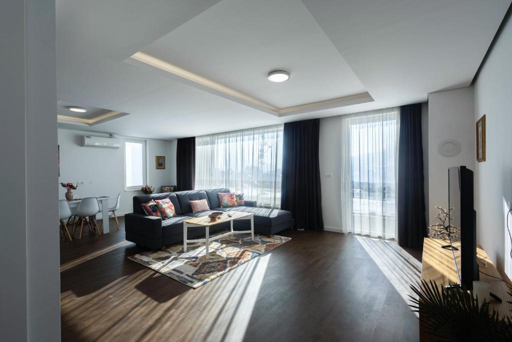 a living room with a couch and a table at Aeris Residence Panoramic View in Sarajevo