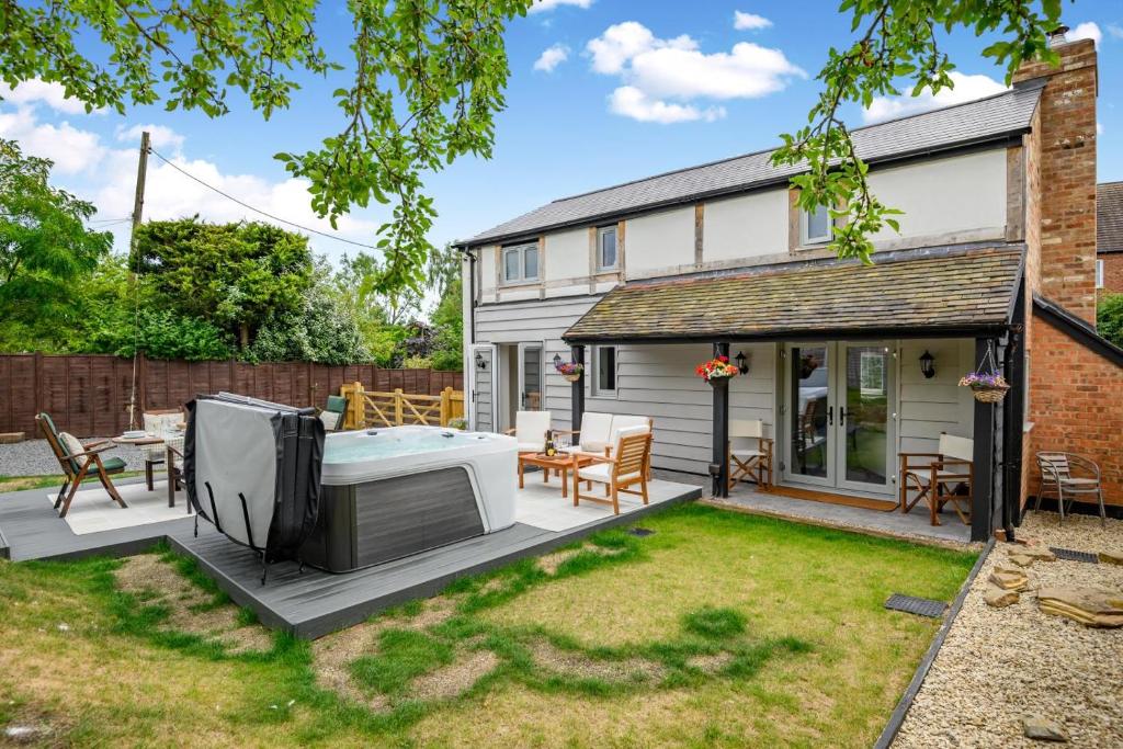 a garden with a hot tub and a patio at 3 Bed in Alfrick oc-s32386 in Broadwas