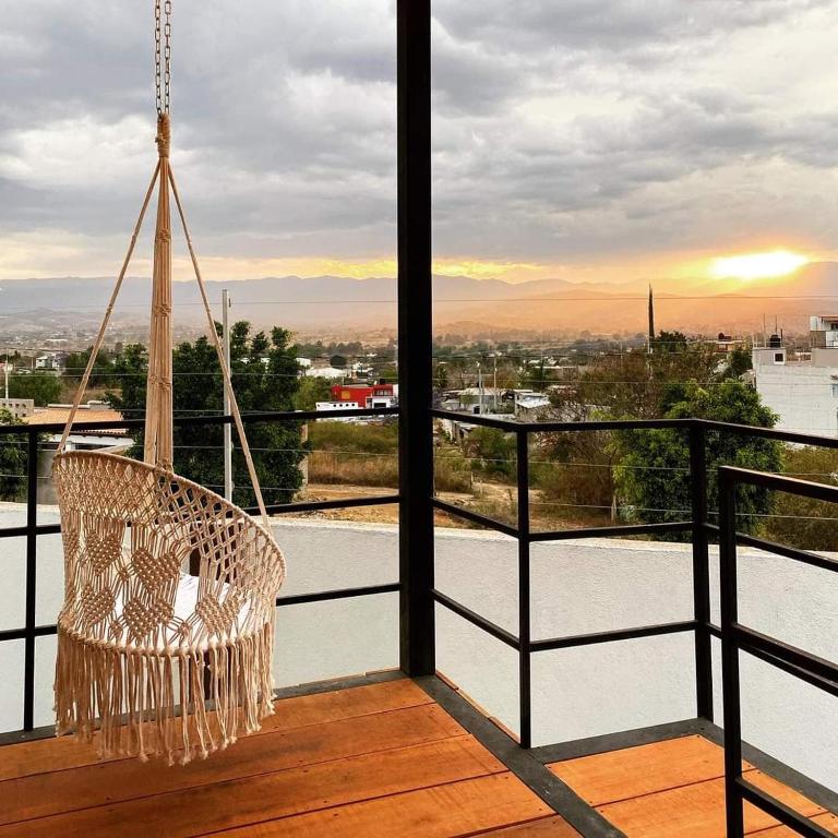 a swinging chair on a balcony with a view at Casa Terraza Oaxaca in San Sebastián Etla