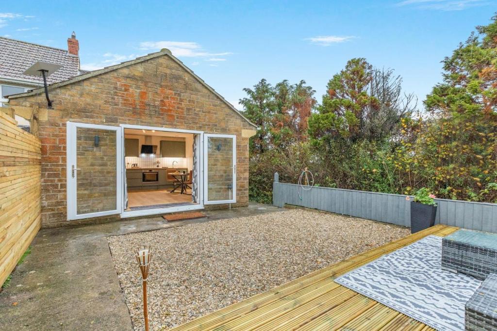 a backyard of a brick house with a patio at 1 Bed in Ashcott oc-m33651 in Ashcott