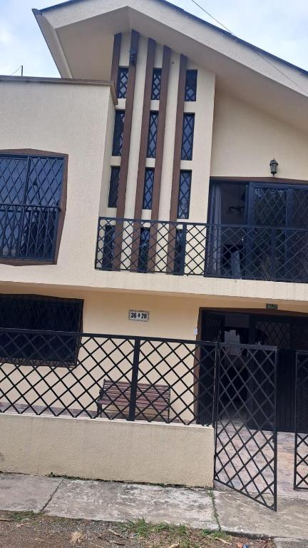 a house with a fence in front of it at Hotel Casa Franco in Cali