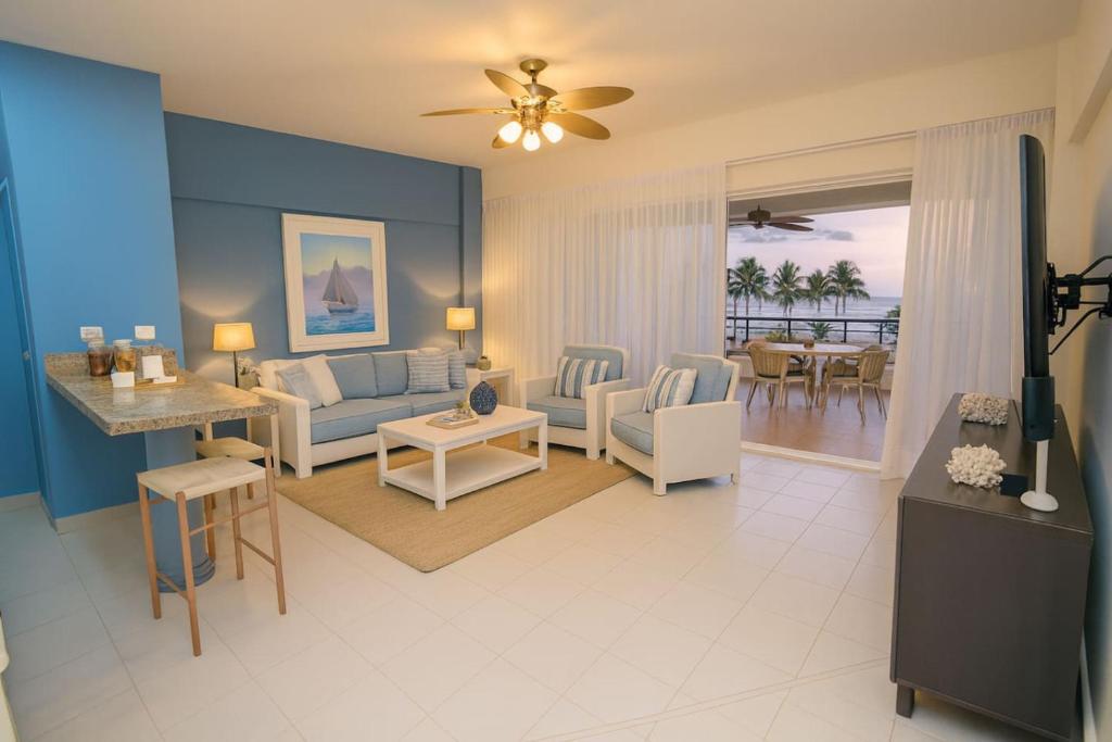 a living room with a couch and a table at Stunning Beachfront 2BR Condo in Juan Dolio in Juan Dolio