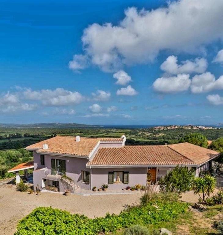 a large white house with a tile roof at Villa Bellavista Palau in Barrabisa