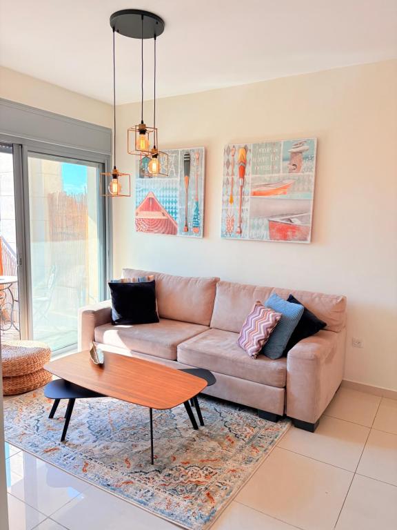 a living room with a couch and a coffee table at ERA home boutique in Eilat