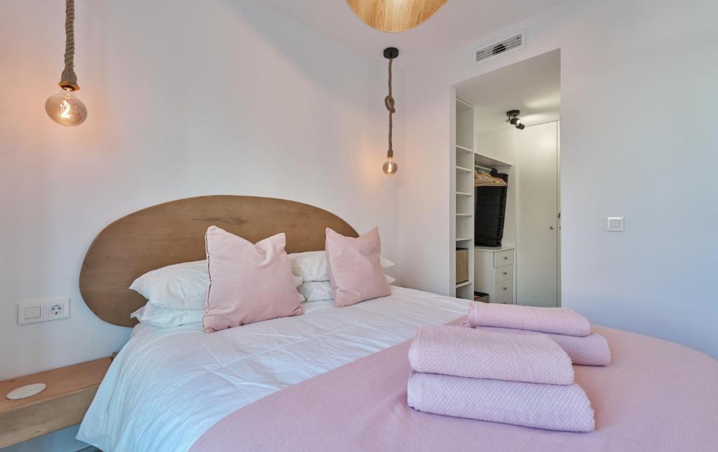 a bedroom with a large bed with pink towels on it at Sea Casa Rosa in Mijas Costa
