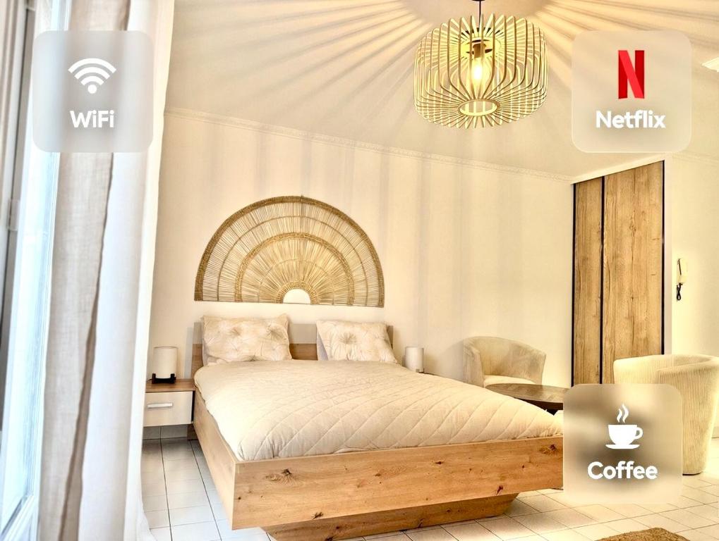 a bedroom with a bed and a chandelier at Le Matin bohème Paris- Orly- By Chozen in Épinay-sur-Orge