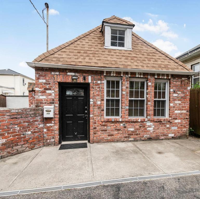 a red brick house with a black door at Cozy cottage close to NYC in Yonkers