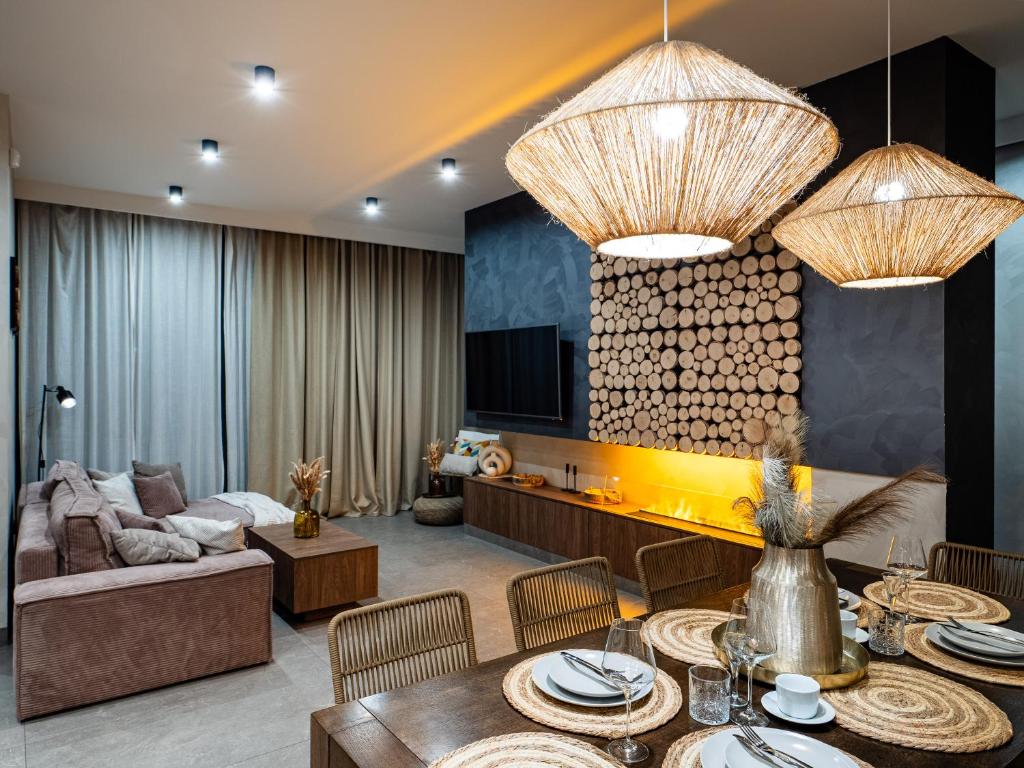 a living room with a couch and a table at LookTatry Tatra Stone House z Jacuzzi in Kościelisko