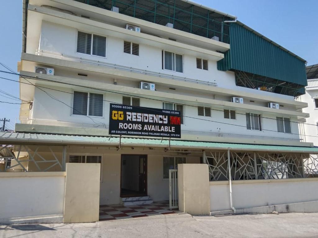 a large white building with a sign in front of it at GG Residency INN in Palakkad