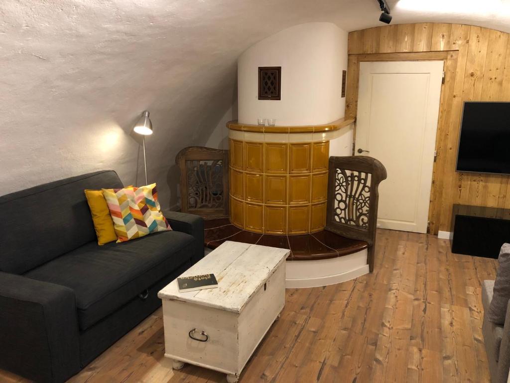 a living room with a couch and a fireplace at TrailHouse in Liptovský Mikuláš