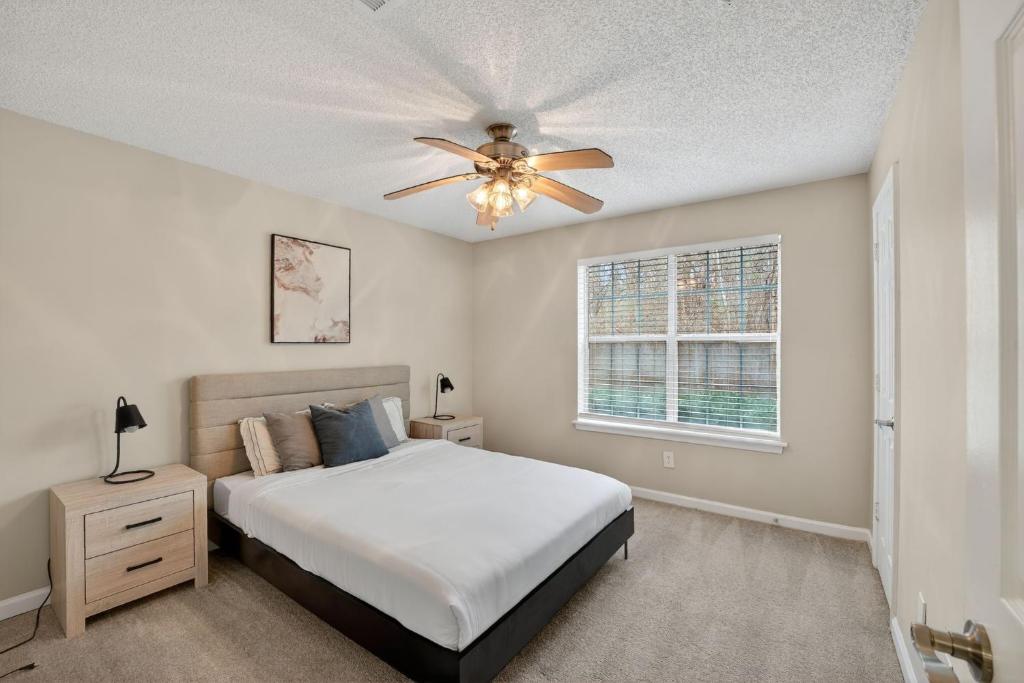 a bedroom with a bed and a ceiling fan at Stylish 2BR2BA with room to unwind in Stockbridge