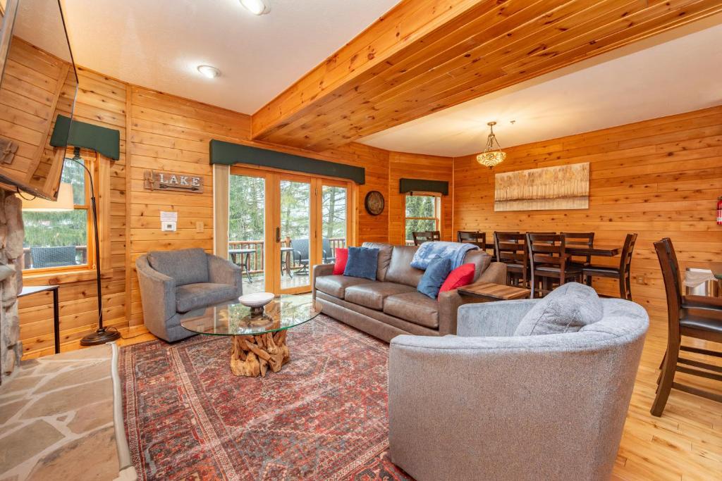 a living room with a couch and chairs and a table at Cedar Shores Villa #06 by Railey Vacations in McHenry