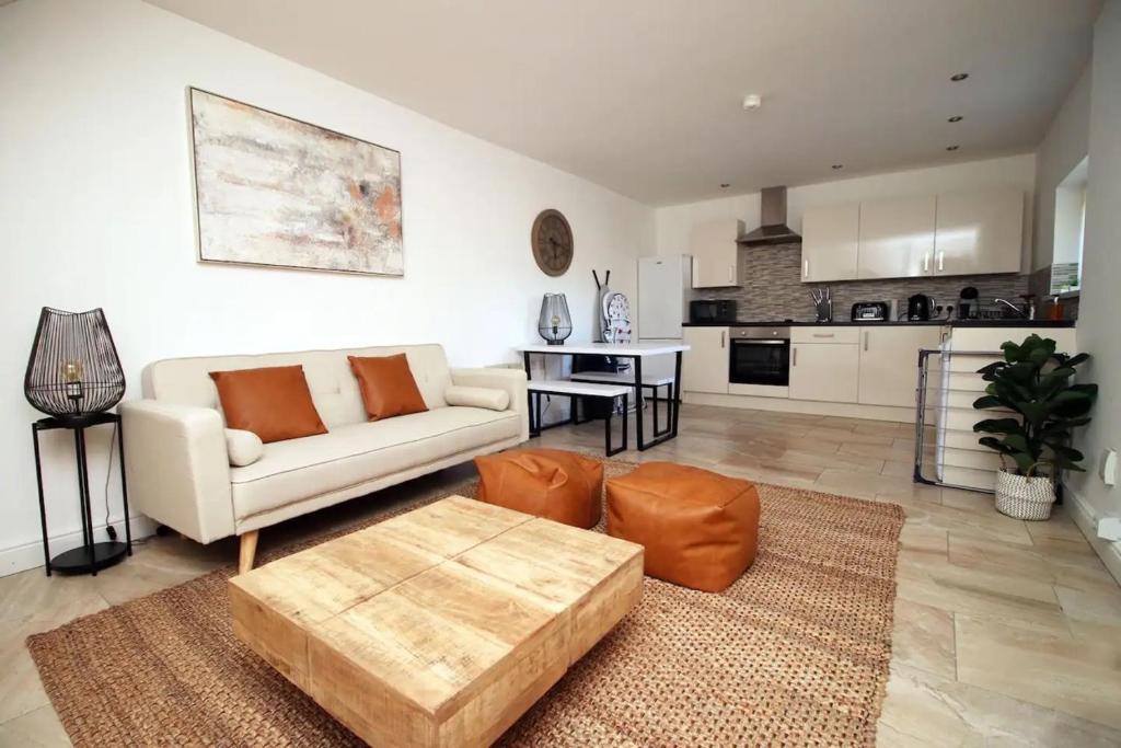 a living room with a couch and a table at Rustic Retreat Opposite Stadium in Cardiff