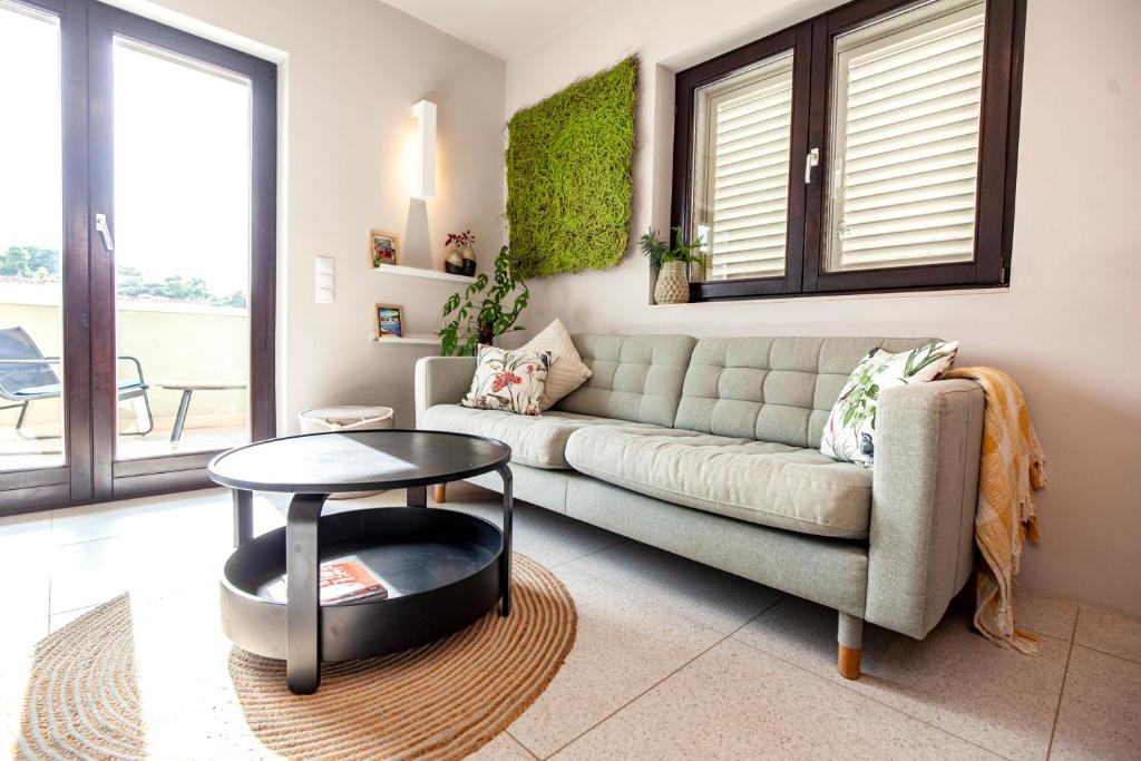 a living room with a couch and a table at Apartmani Vale in Hvar