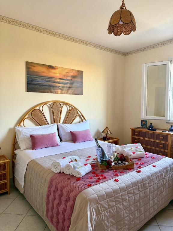 a bedroom with a large bed with flowers on it at Aspra Mare House in Aspra