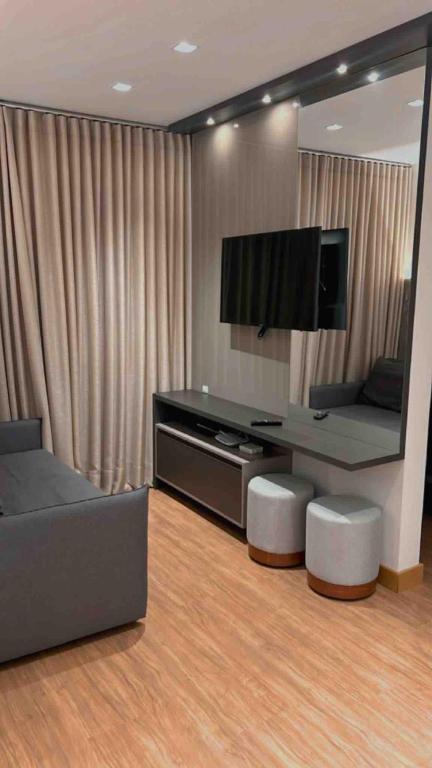 a living room with a couch and a television at AP1011 Gray Eleven in Santa Maria