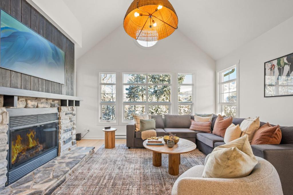 a living room with a couch and a fireplace at Tremblant Prestige - Les Eaux 221-3 in Mont-Tremblant