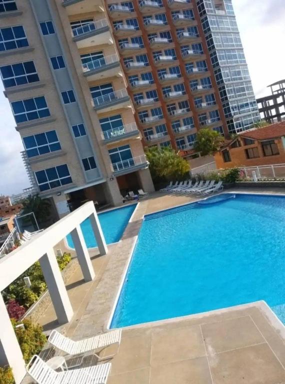 a swimming pool in front of a building at PREMIUM Puerto Varadero Apartamento con Vista al Mar y Planta Total in Tucacas