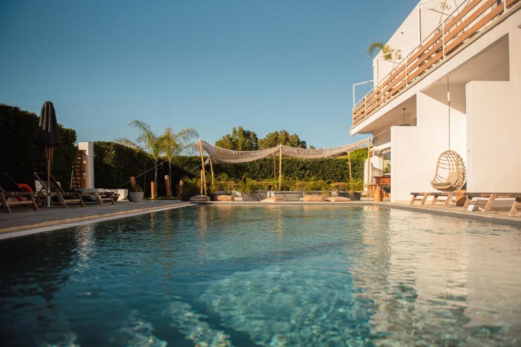 a swimming pool in the middle of a building at BOHOTEL Messonghi - Designer's Hotel in Mesongi