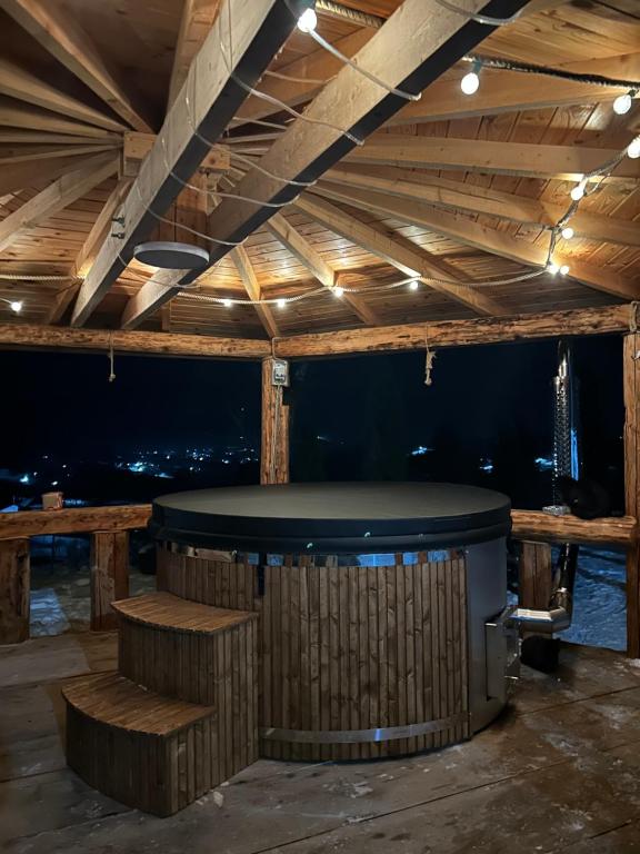 a bar with a table and benches in a room at Casa Șaru Bucovinei in Şaru Bucovinei