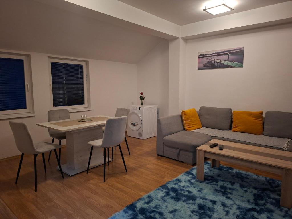 a living room with a couch and a table at FLAMANITA APARTMENTS in Skopje