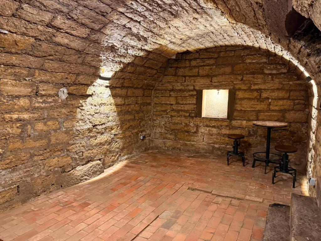 a room with a table and chairs in a brick wall at Ferienwohnung Beutelsbacherstr. 12 B in Stuttgart