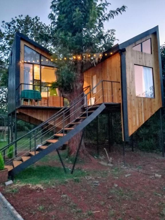 a tree house with a staircase leading up to it at Lux tree house karen in Nairobi
