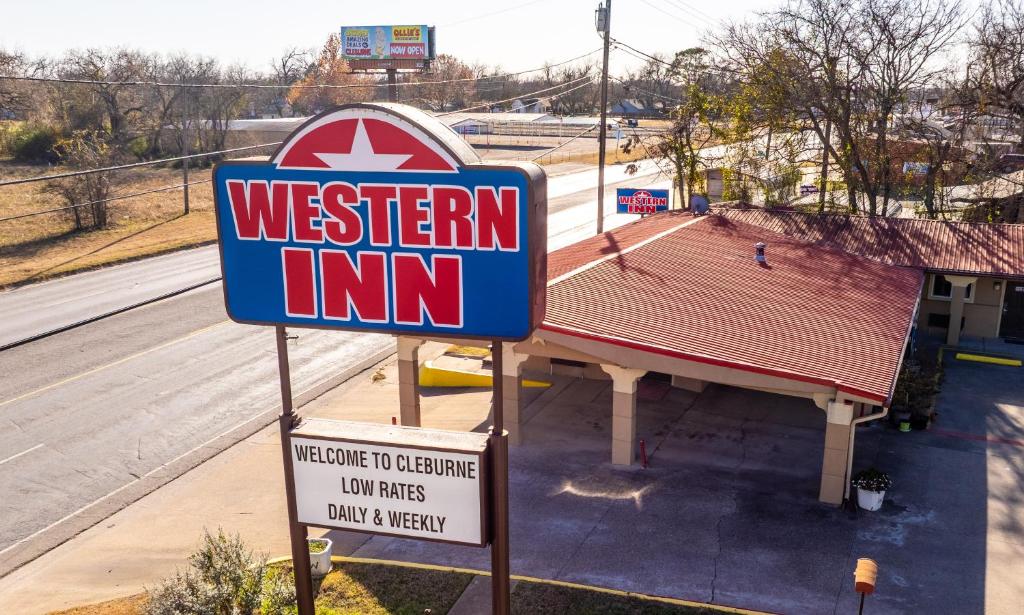 a sign for a western inn in front of a building at Western Inn by Capital O Cleburne TX in Cleburne