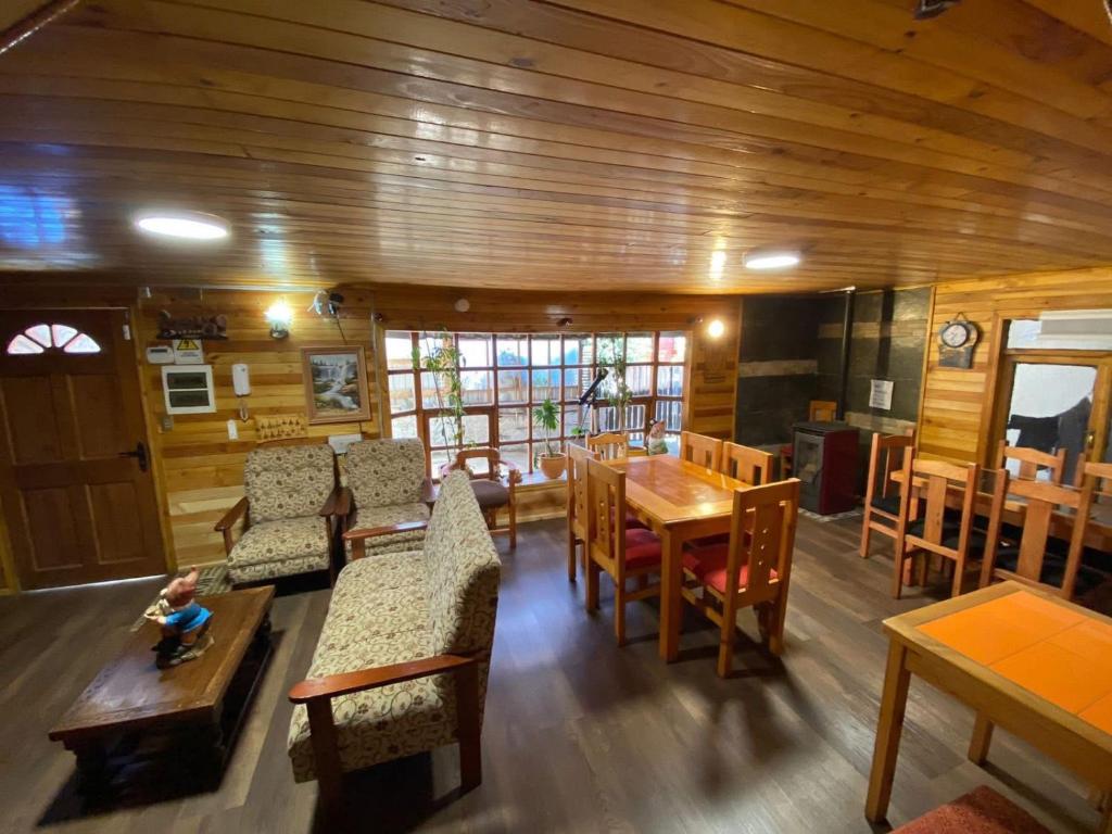 a dining room with wooden walls and tables and chairs at Chiloe Seta in Ancud