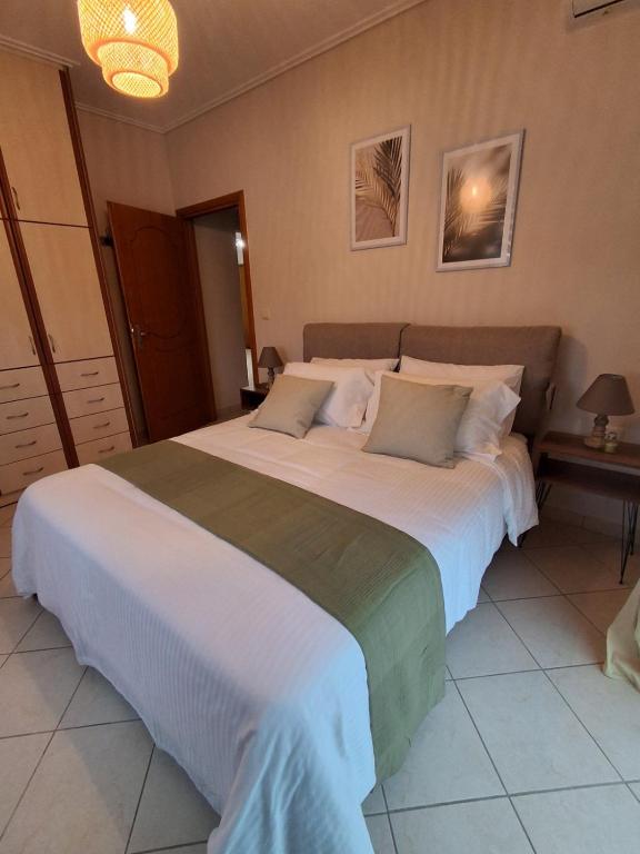 a bedroom with a large white bed with two pillows at Marbi Apartment in Tripoli