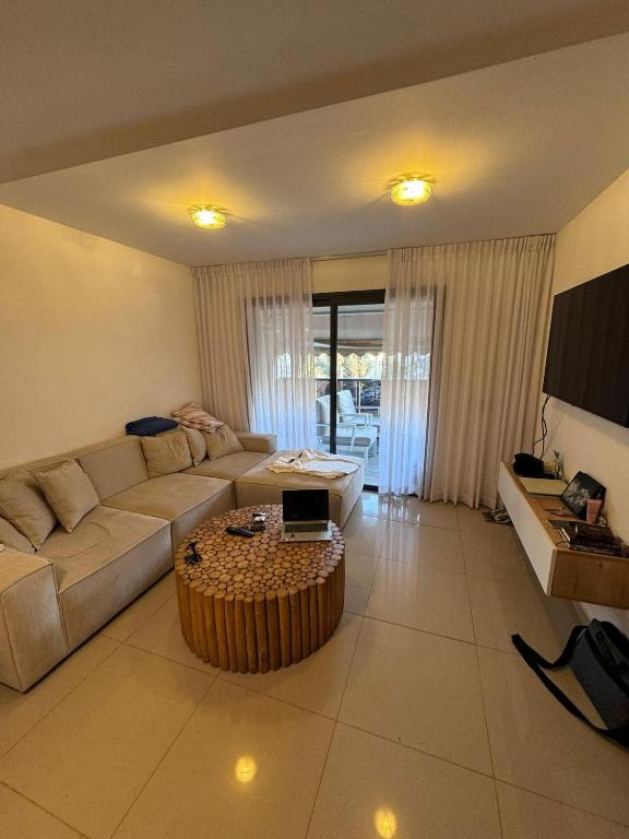 a living room with a couch and a table at Boutique in Rothschild in Rishon LeẔiyyon