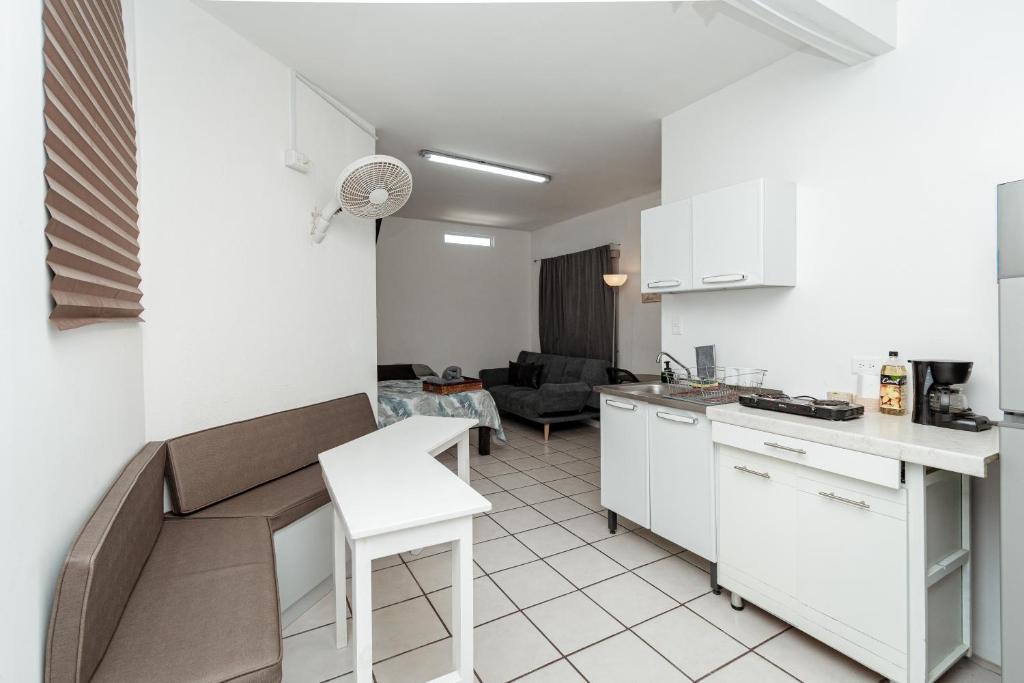 a kitchen and living room with a couch and a table at Departamento Palmito in La Paz