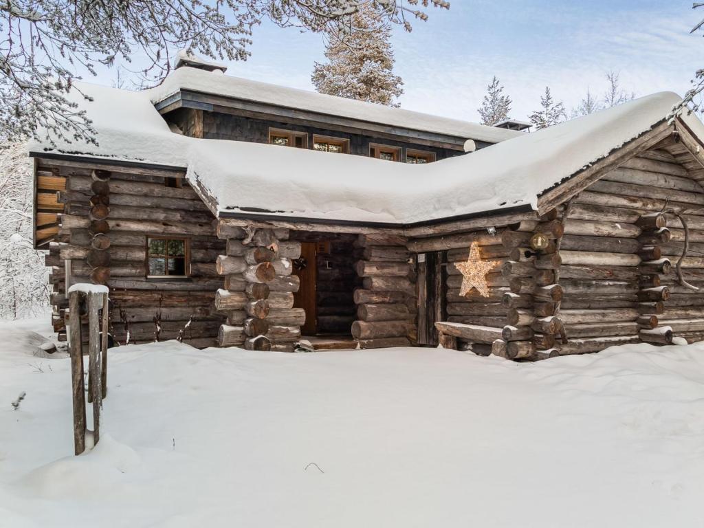 a log cabin with snow on the roof at Holiday Home Ylläspollu a by Interhome in Ylläsjärvi