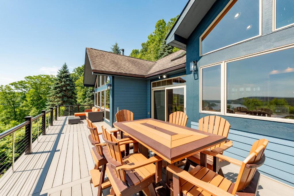 a deck with a wooden table and chairs at Rocky Mountain Lodge by Railey Vacations in McHenry