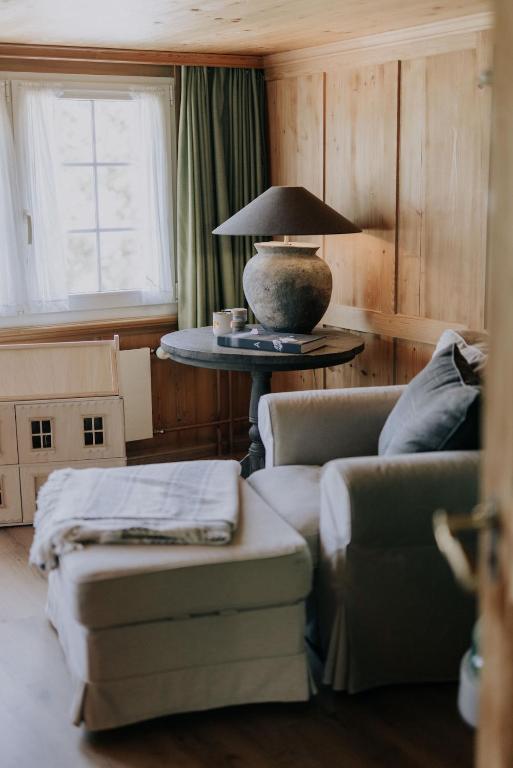 a living room with a couch and a table with a lamp at 4 bedroom house for 8 guests in Brülisau
