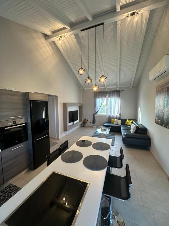 a kitchen and living room with a table and a couch at Theros 1 in Xanthi