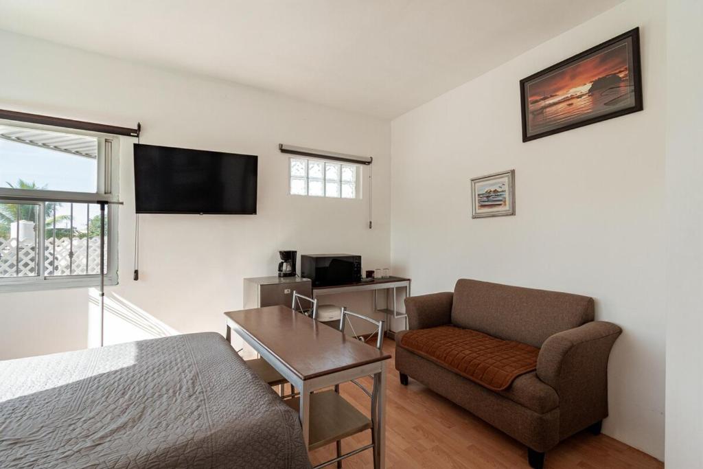 a bedroom with a bed and a chair and a desk at Departamento Palmerín in La Paz