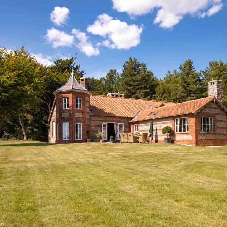 a large brick house with a large yard at The Shooting Lodge in Charminster