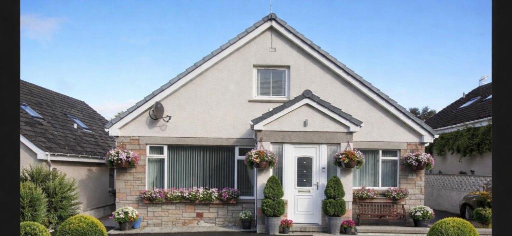 a house with flowers in front of it at Crayford's Guest House in Aberdeen